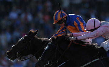 Jockey Ryan Moore (L) atop Magician edges William Buick atop The Fugue to win the Turf during the 2013 Breeders' Cup World Championships at Santa Anita Park on November 2, 2013